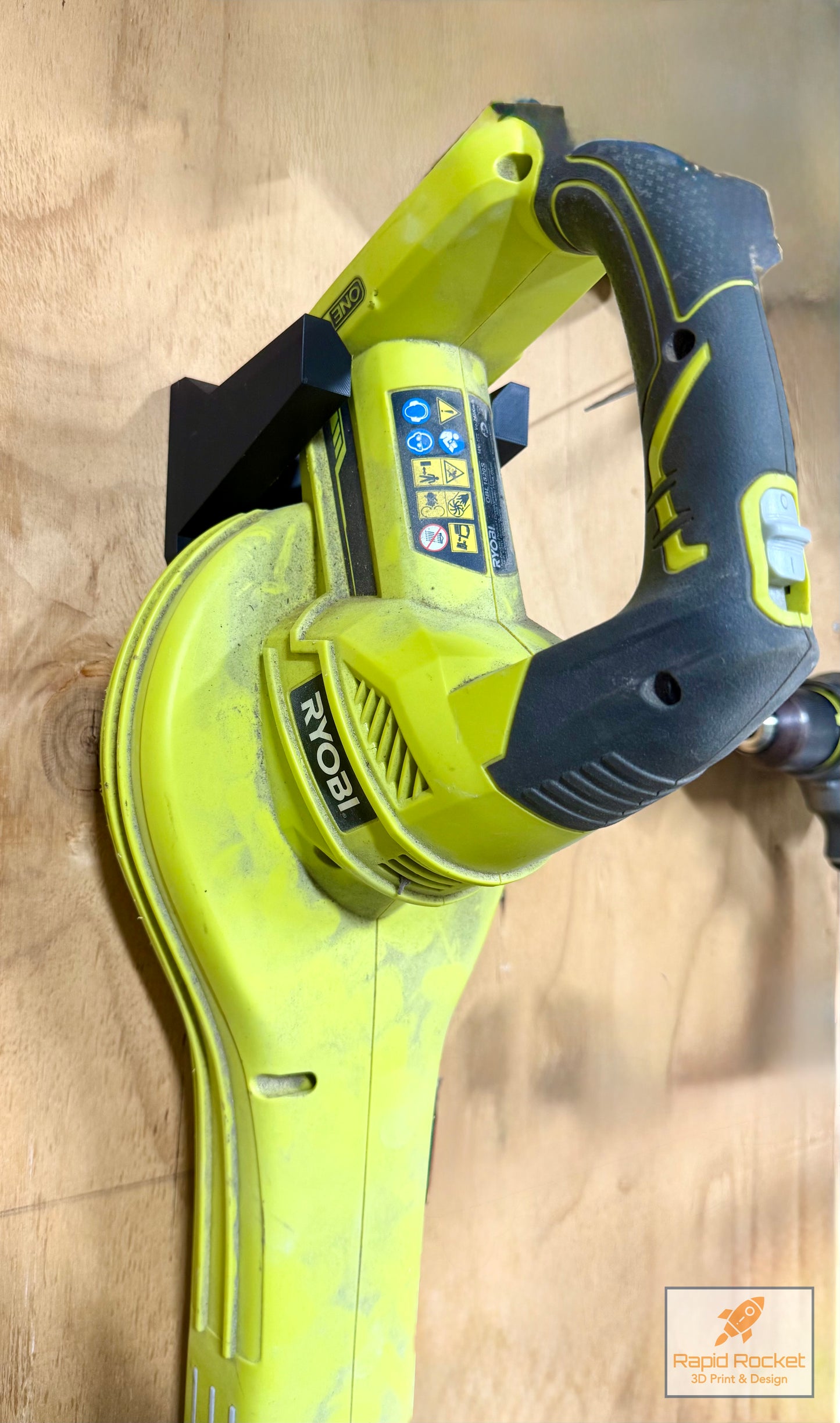 Green and black power tool on a wooden surface