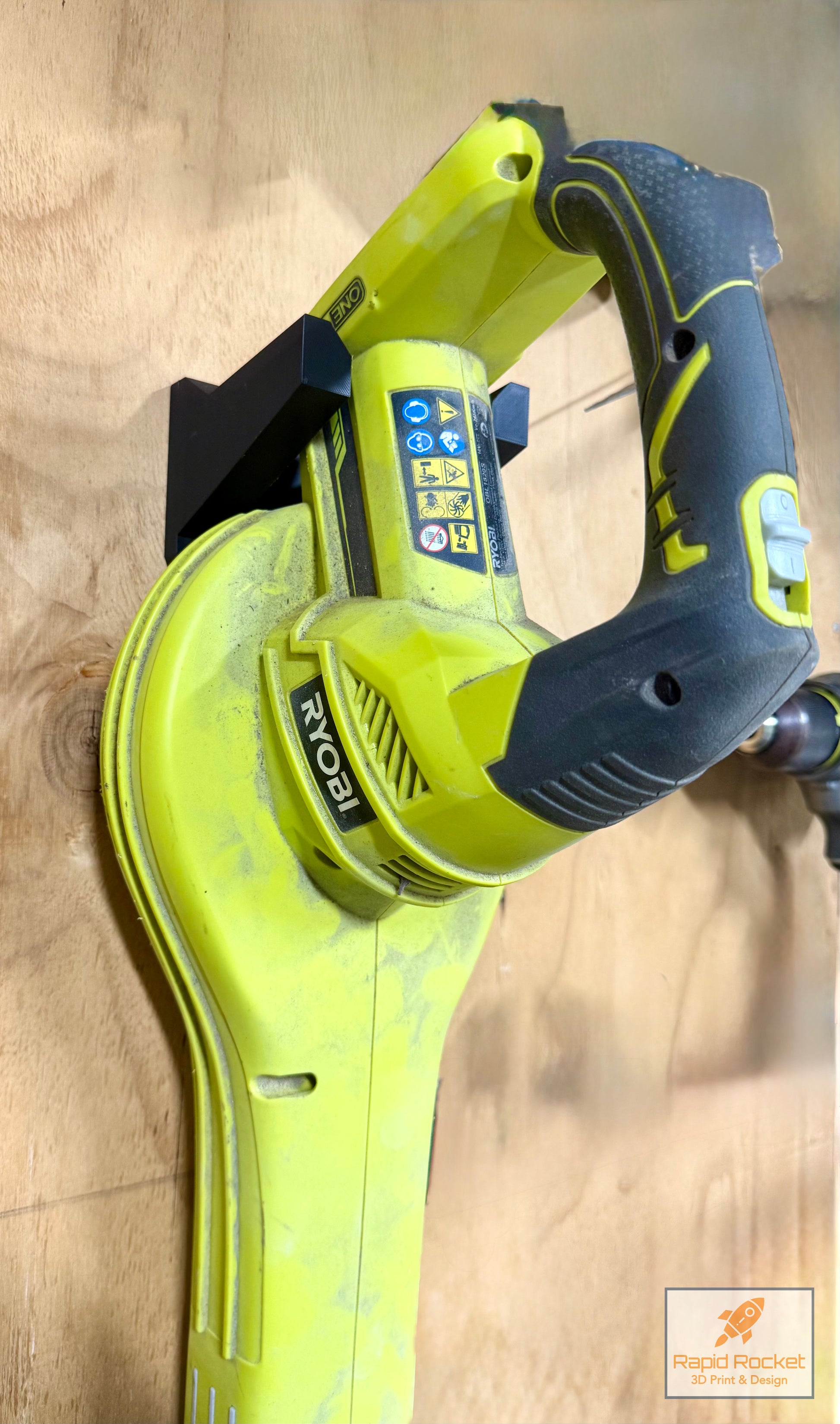 Green and black power tool on a wooden surface
